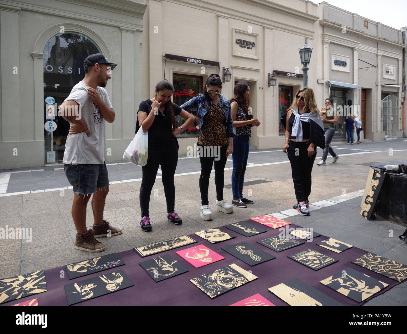Cordoba, Argentina - 2018: An artist sells paintings on the street to tourist in the downtown district. Stock Photo