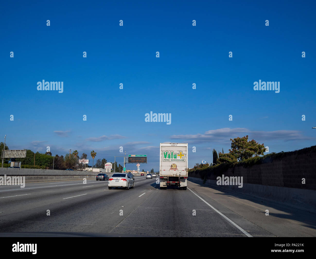 Los Angeles, MAR 25: Beautiful blue sky on the highway with valu food warehouse truck on MAR 25, 2018 at Los Angeles, California Stock Photo