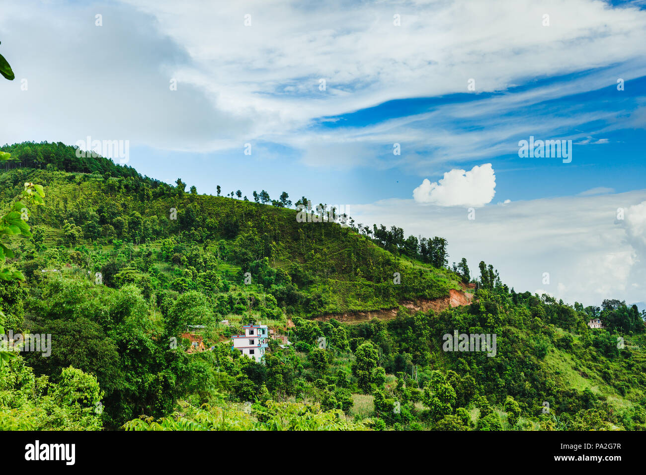 Scenery of beautiful Nepali rural village with mountains  and green forest.It is in the hilly region of Gorkha Nepal.Breathtaking view,Dramatic and pi Stock Photo
