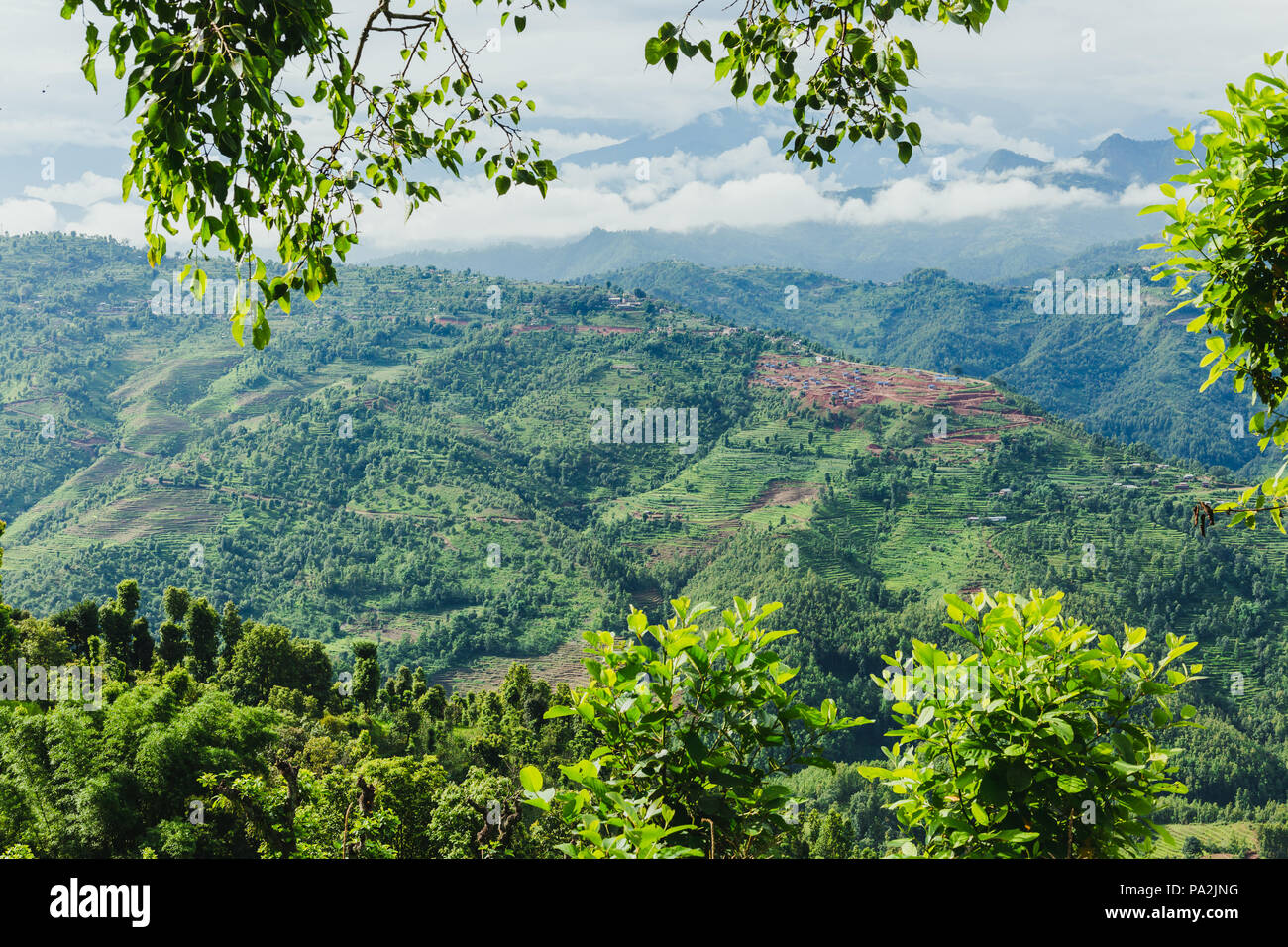 Scenery of beautiful Nepali rural village with mountains  and green forest.It is in the hilly region of Gorkha Nepal.Breathtaking view,Dramatic and pi Stock Photo