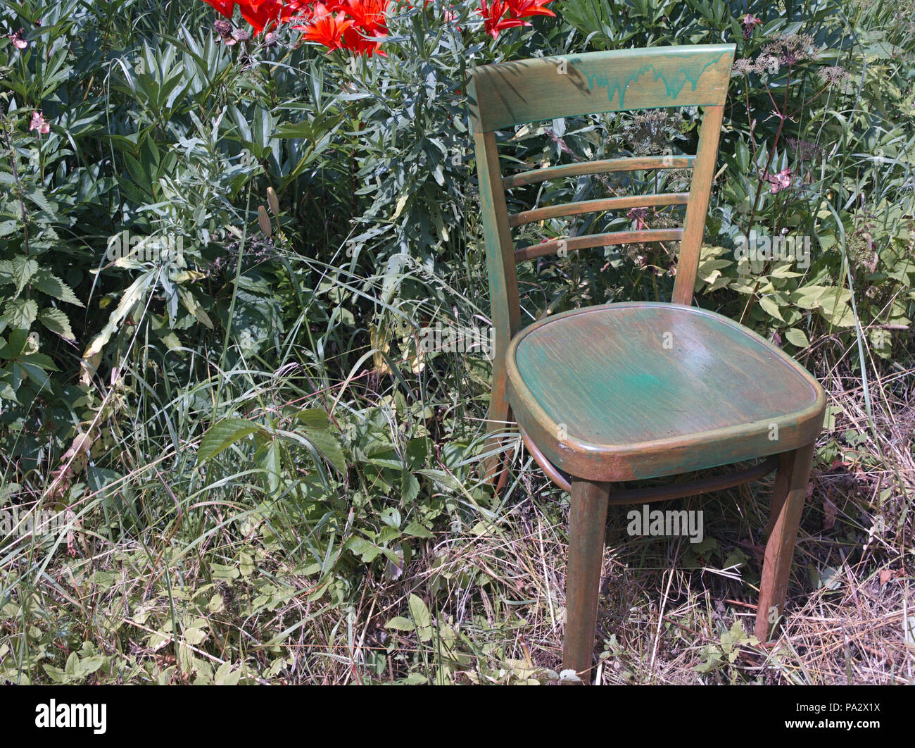 An Old Green Painted Chair In A Garden Outdoor Closeup Stock