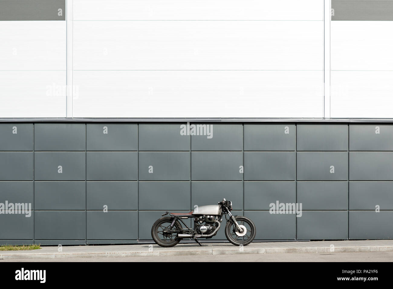 Custom Motorbike Parking Near Gray Wall Of Finance Building