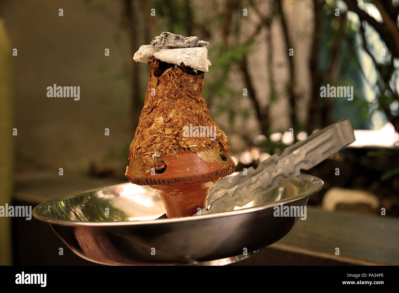 isfahani tobacco ajami Ajami tobacco leaves burning in a hookah head, vintage colors Stock Photo