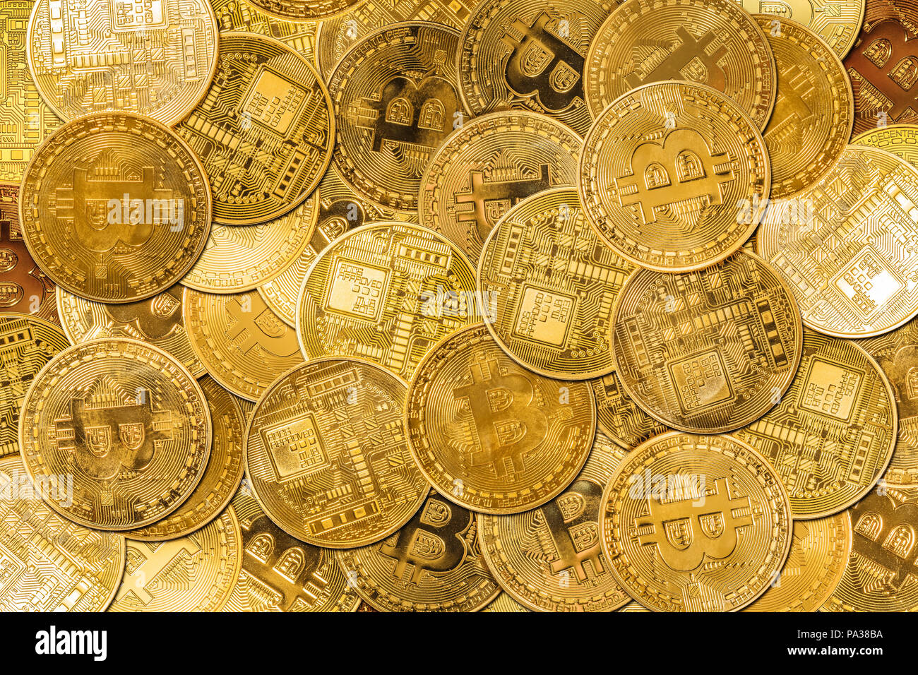 Golden bitcoin coins background of currency. Financial golden background. New virtual money and crypto-currency. Flat lay shot. Stock Photo