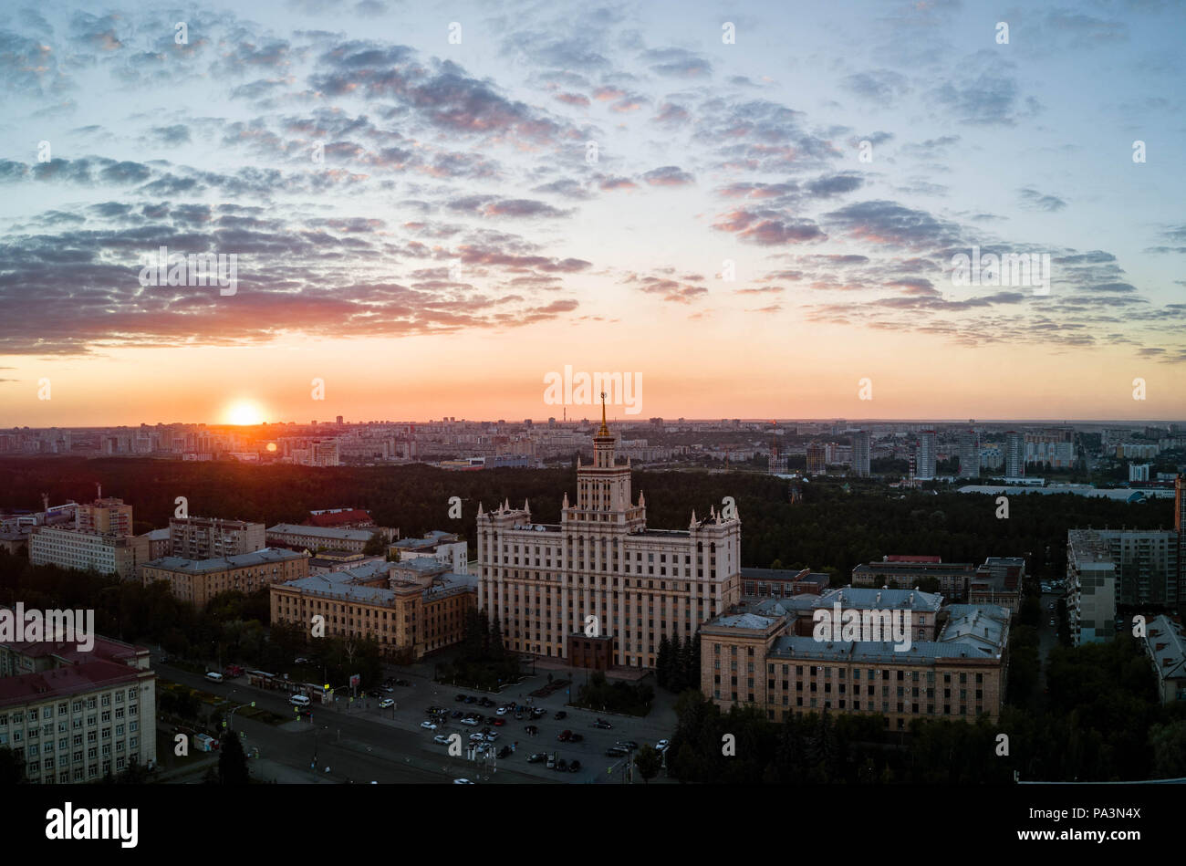 Aerial drone panoramic view of university campus in the city center of Chelyabinsk, huge city park with coniferous forest, recreation zone in polluted Stock Photo