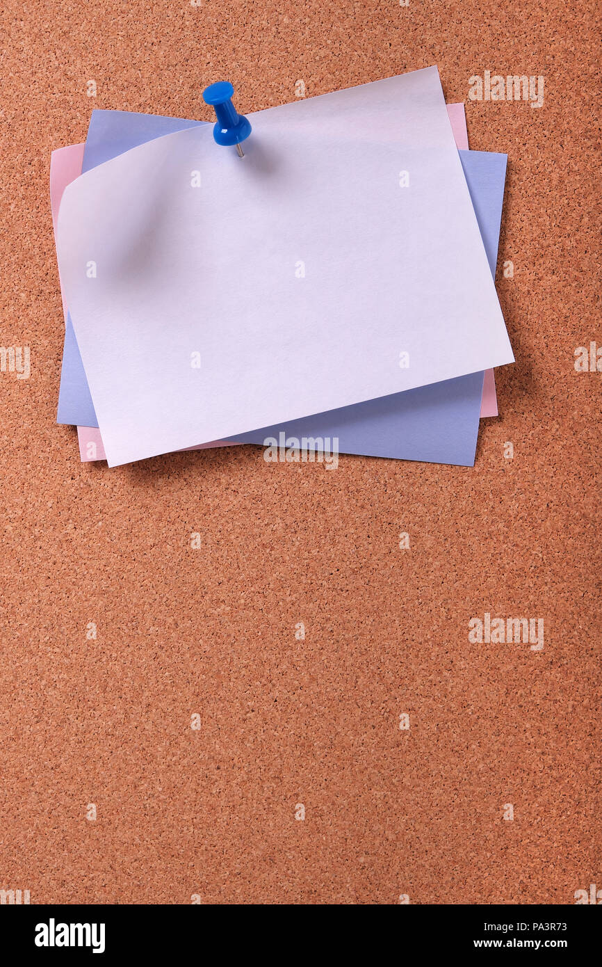 Several various colors sticky post notes vertical cork background Stock Photo