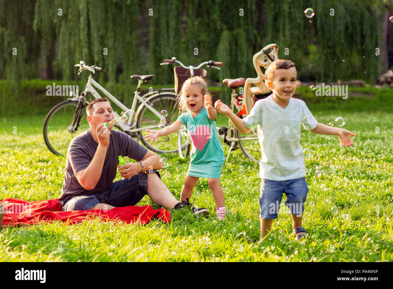 family time- Happy father with children blow soap bubbles outdoor Stock ...