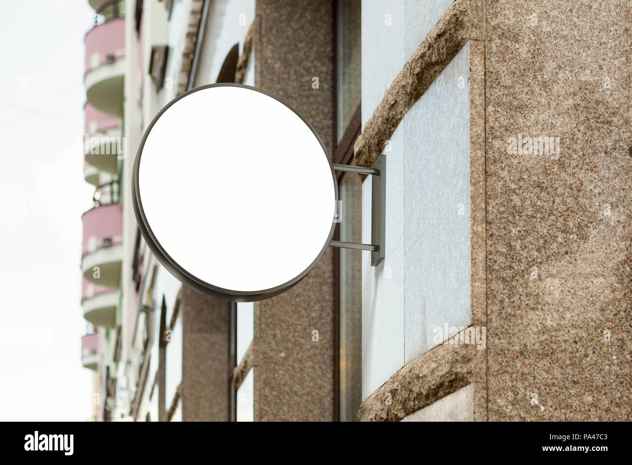 Blank shop sign on granite wall. Round signage mockup. 3d illustration