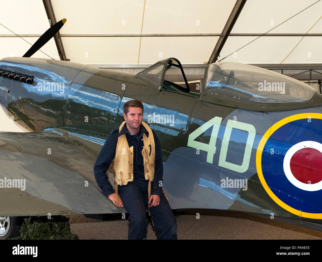 Man In Period Pilots Uniform Poses By A Supermarine Spitfire Mk XVI Man In Period Pilots Uniform Poses By A Supermarine Spitfire Mk XVI