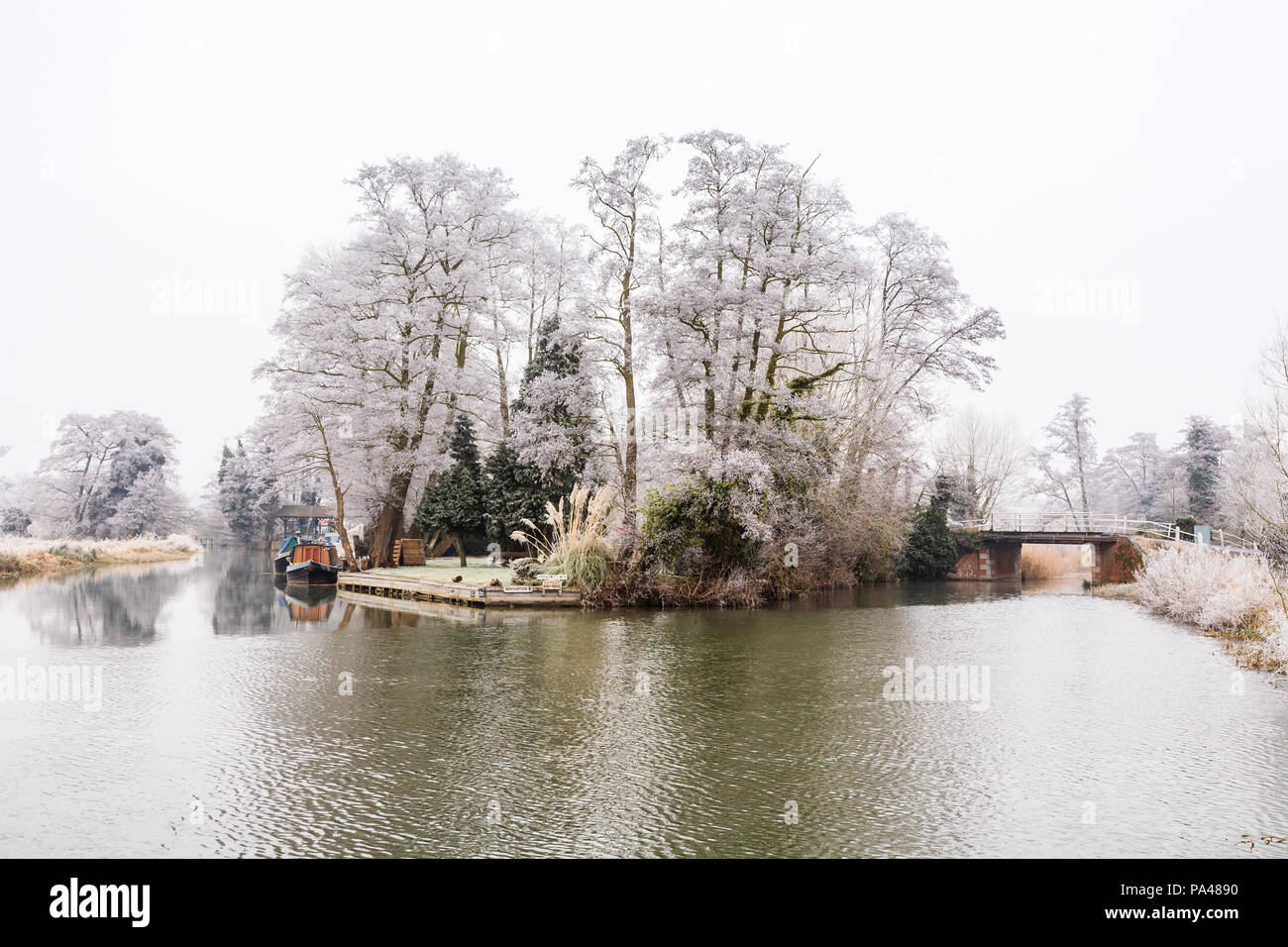 Rural Surrey landscape, southeast England, River Wey with moored narrowboat and road bridge near