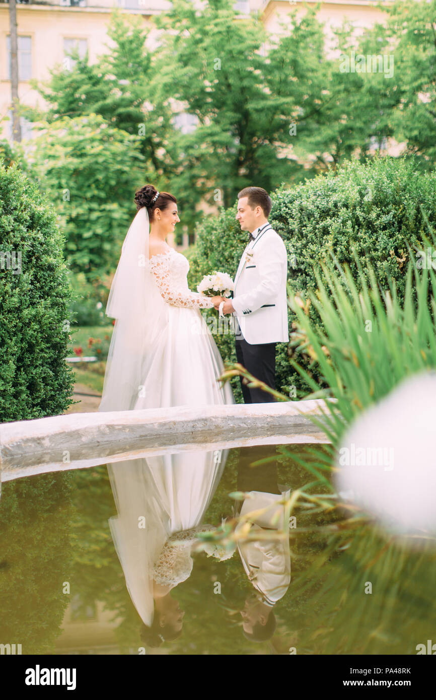 Happy newlyweds posing in park hi-res stock photography and images - Alamy