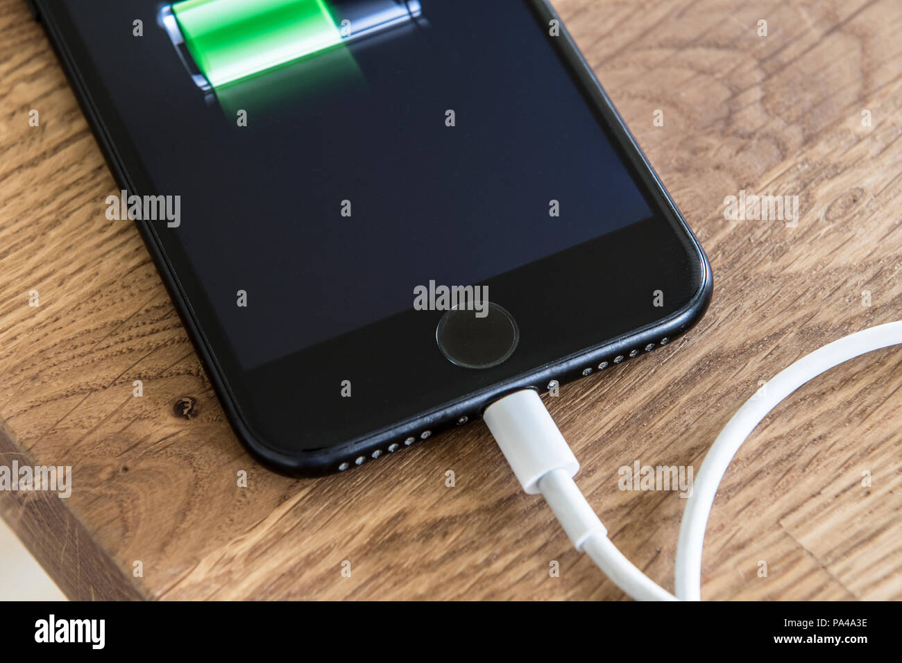 Smart phone on charge plugged on Stock Photo