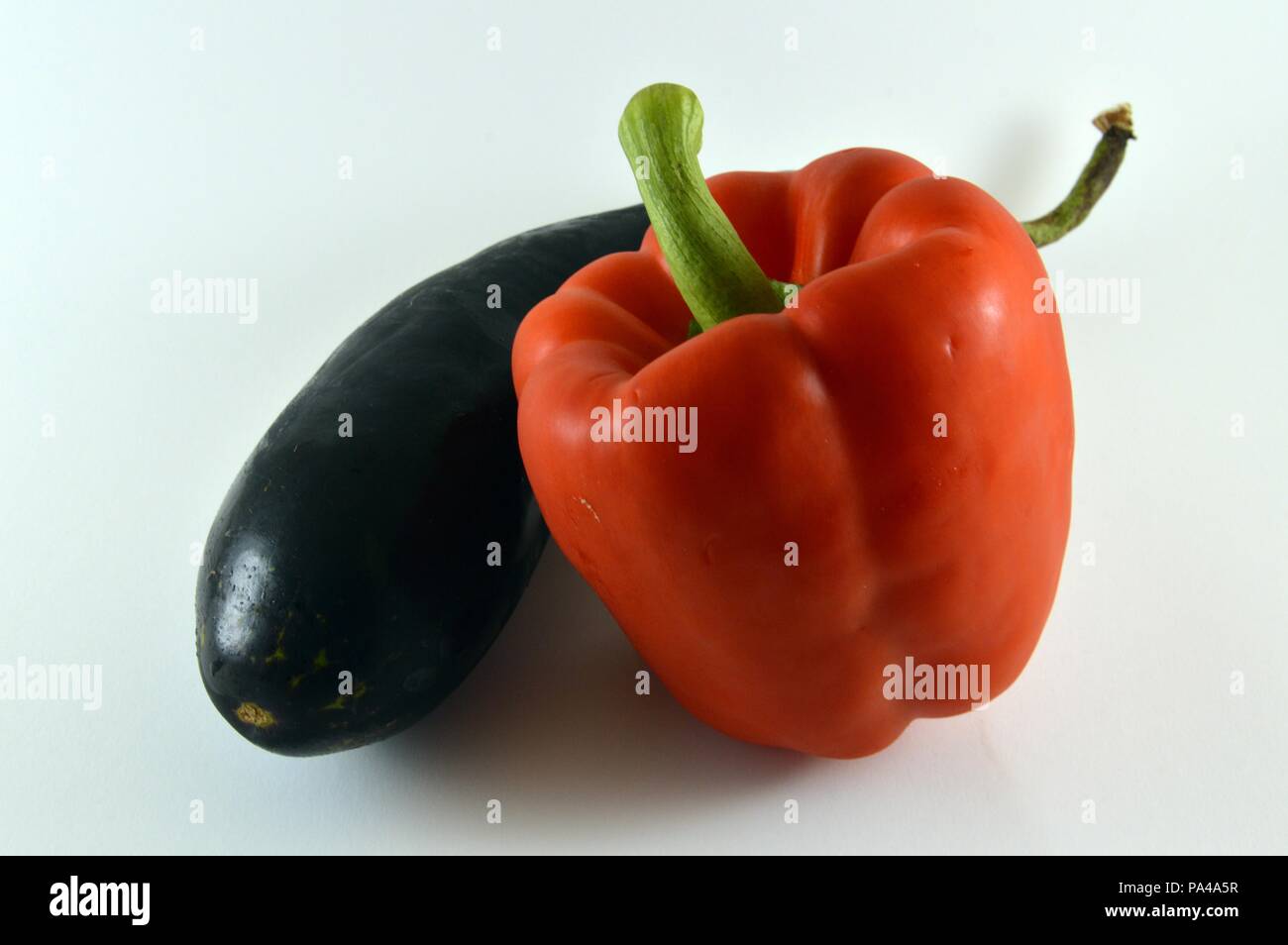 eggplant hugs red pepper Stock Photo