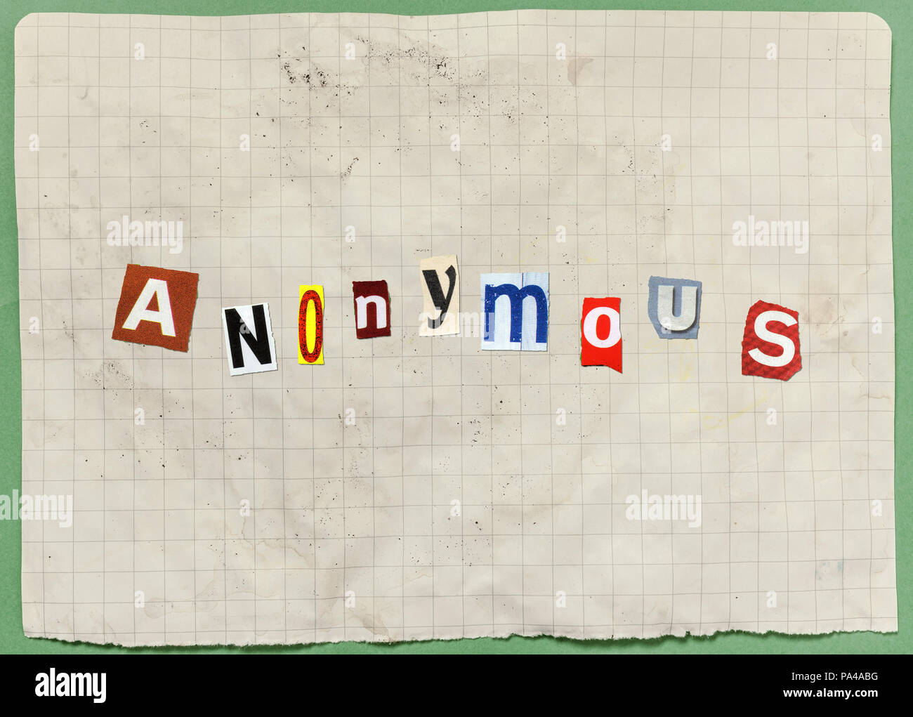 A letter with characters cut out from newspapers and magazines, composing the word Anonymous (an ominous threat or a blackmail attempt). Stock Photo