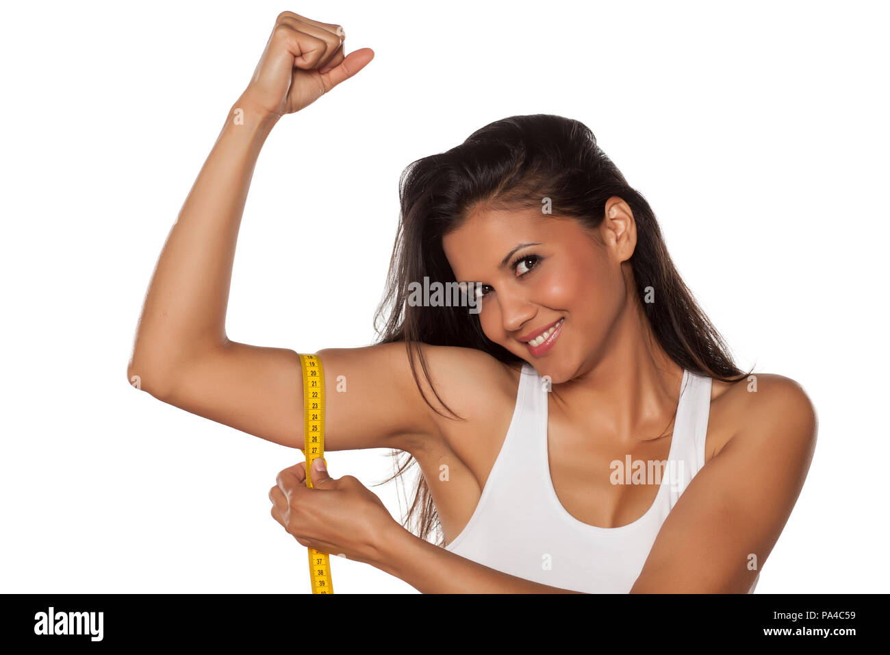 young beautiful woman measured her biceps with a tape measure Stock Photo