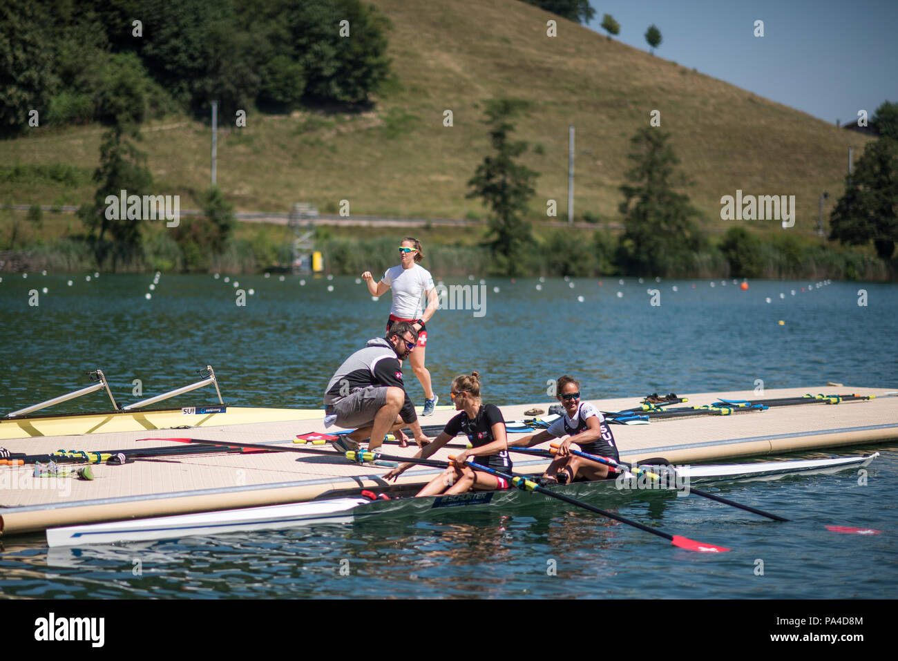 Lucerne, SWITZERLAND, 12th July 2018, Thursday Swiss Rowing, Head Coach, Robin DOWELL, push's the SUI LW2X, 'Lightweight Women's Double Scull',  away from the pontoon,  FISA World Cup III, Lake Rotsee, © Peter SPURRIER, Stock Photo