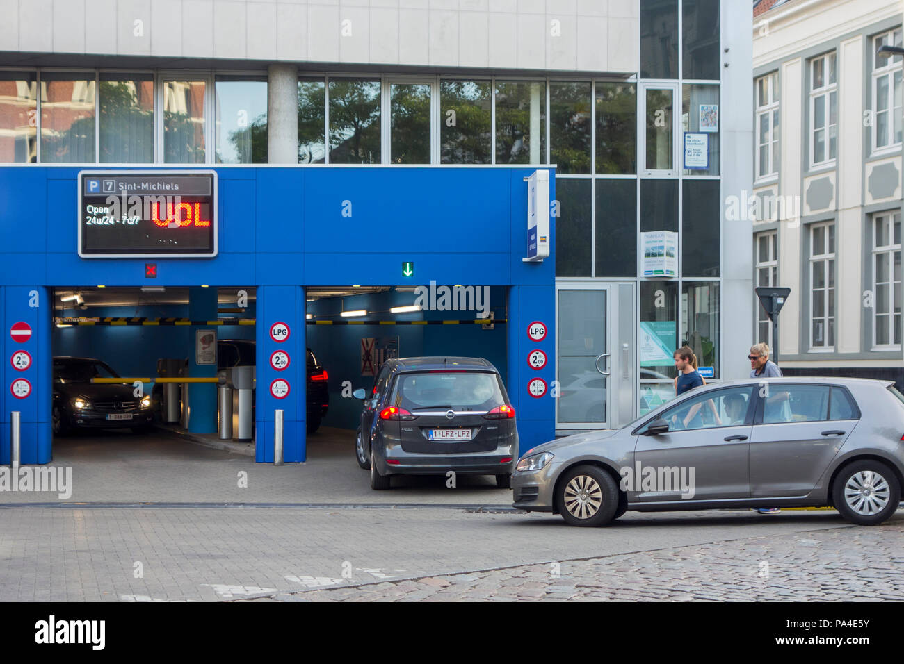 Cars still entering completely filled guarded underground car park in the city centre of Ghent, East Flanders, Belgium Stock Photo