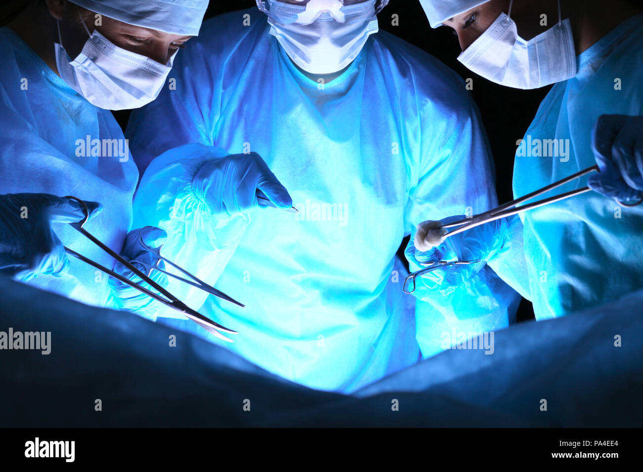 Group of surgeons in masks performing operation. Medicine, surgery and ...