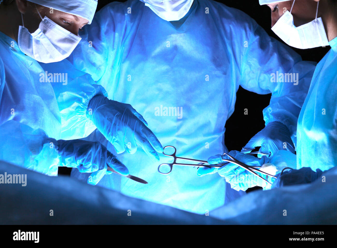 Group of surgeons in masks performing operation. Medicine, surgery and ...