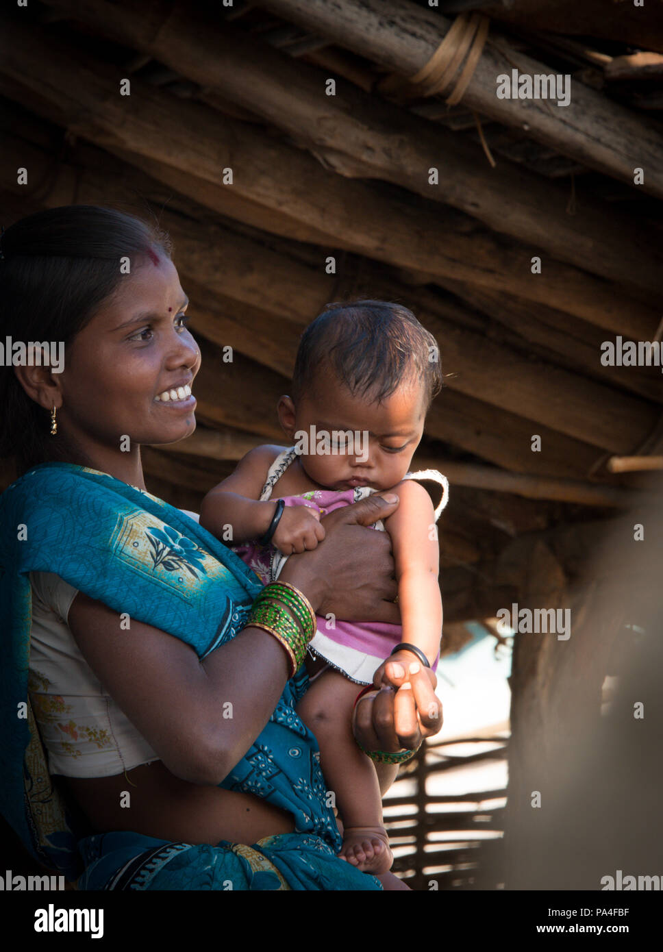 Happy indian mother and baby living in Kanha village near the ...