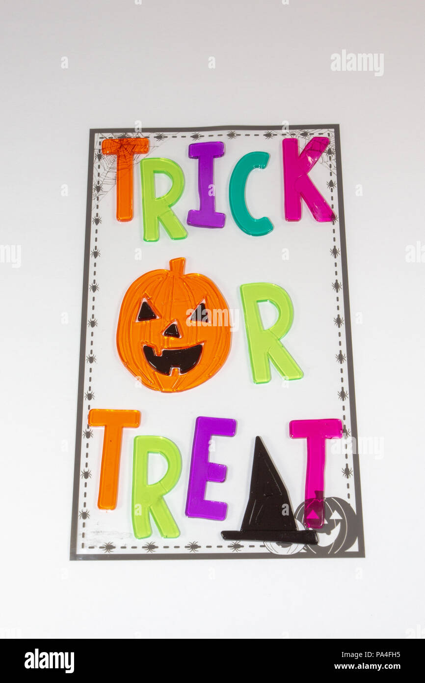 A trick or treat sign with a carved pumpkin and a scary witch hat Stock Photo
