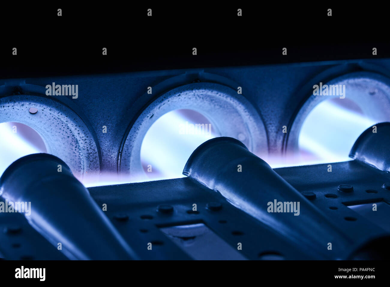 Closeup Shot Of Home Furnace Burner Ignited With Crimson Blue Flame