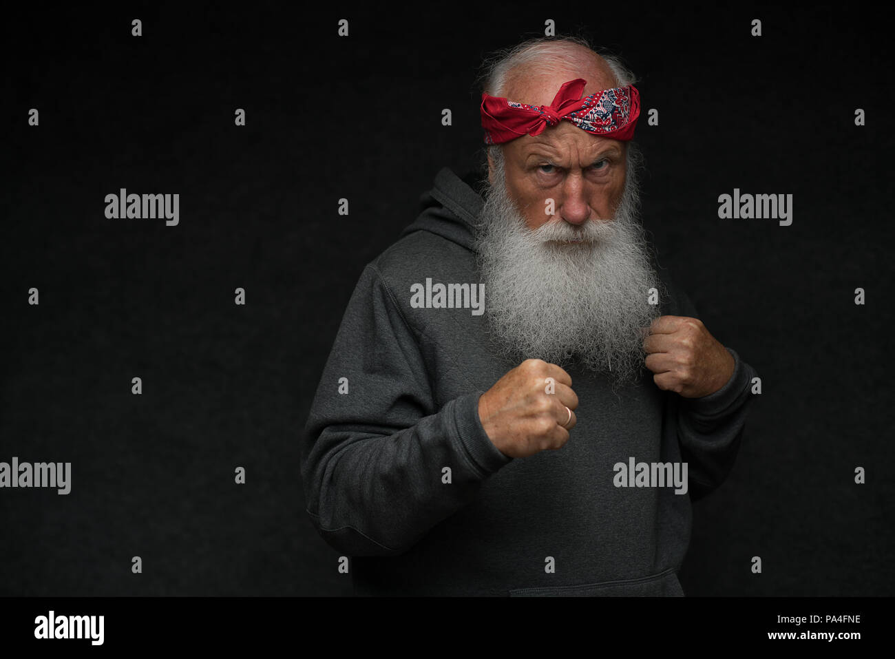 stylish old man with a gray beard on black background Stock Photo