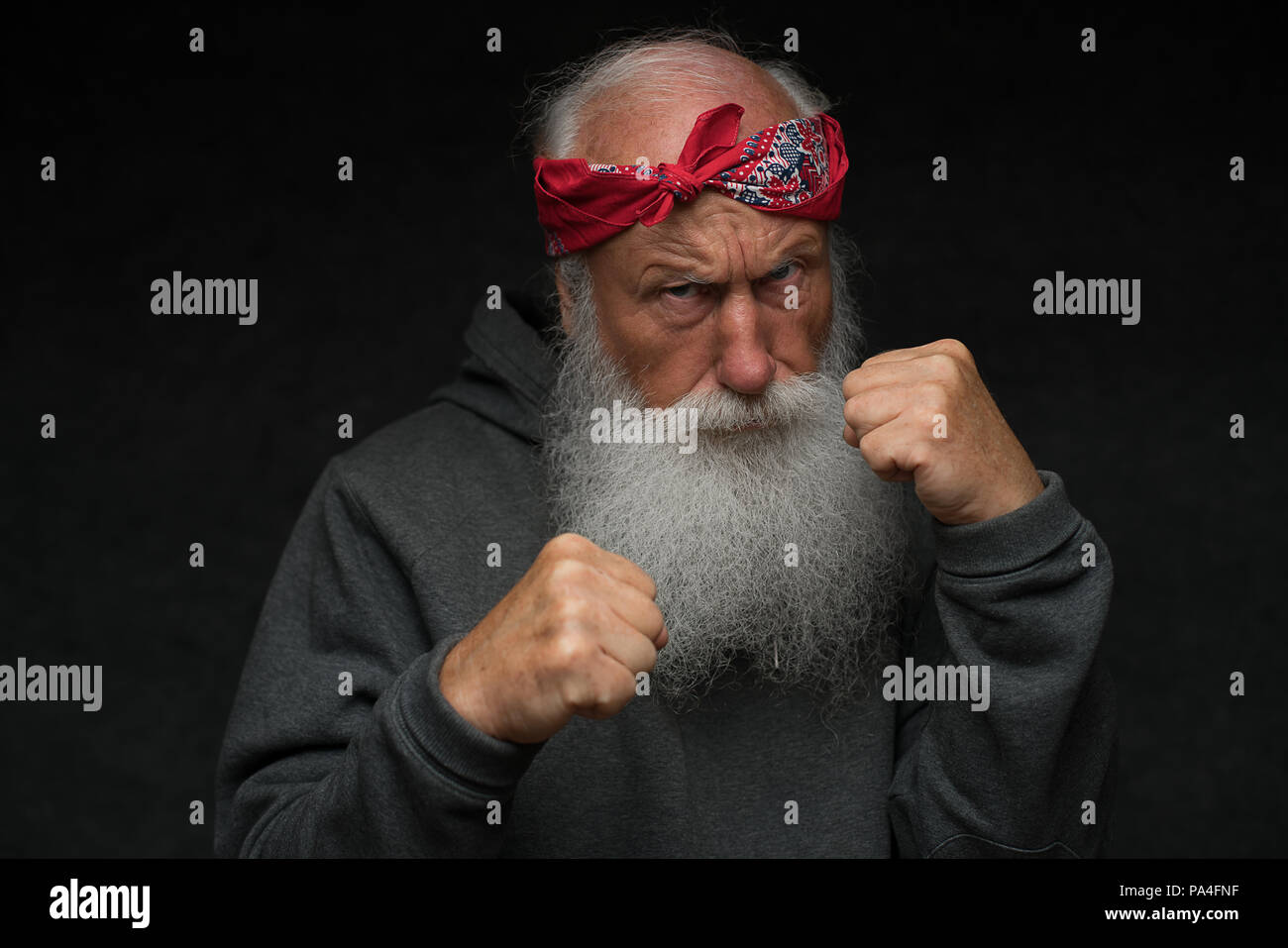stylish old man with a gray beard on black background Stock Photo