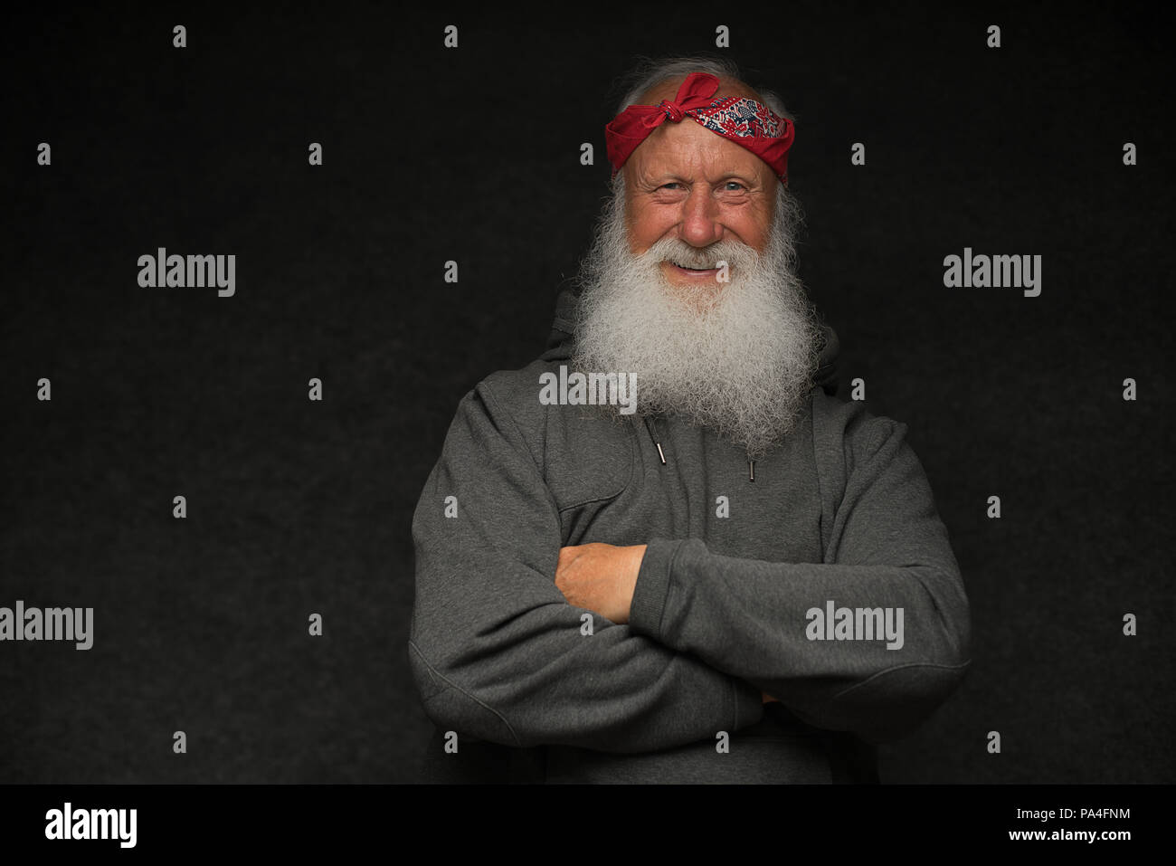 stylish old man with a gray beard on black background Stock Photo