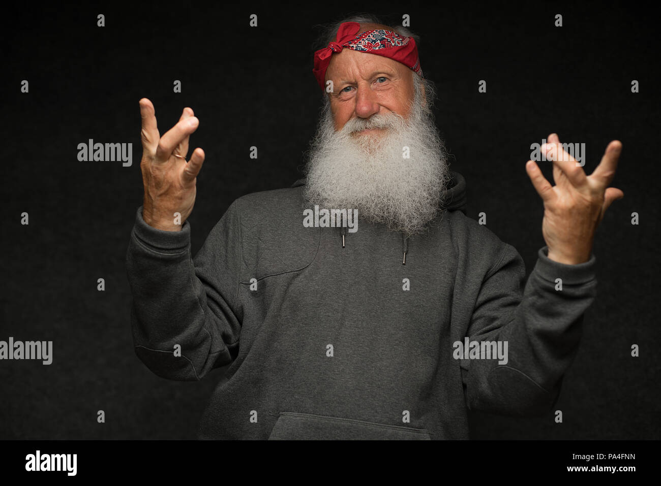 stylish old man with a gray beard on black background Stock Photo