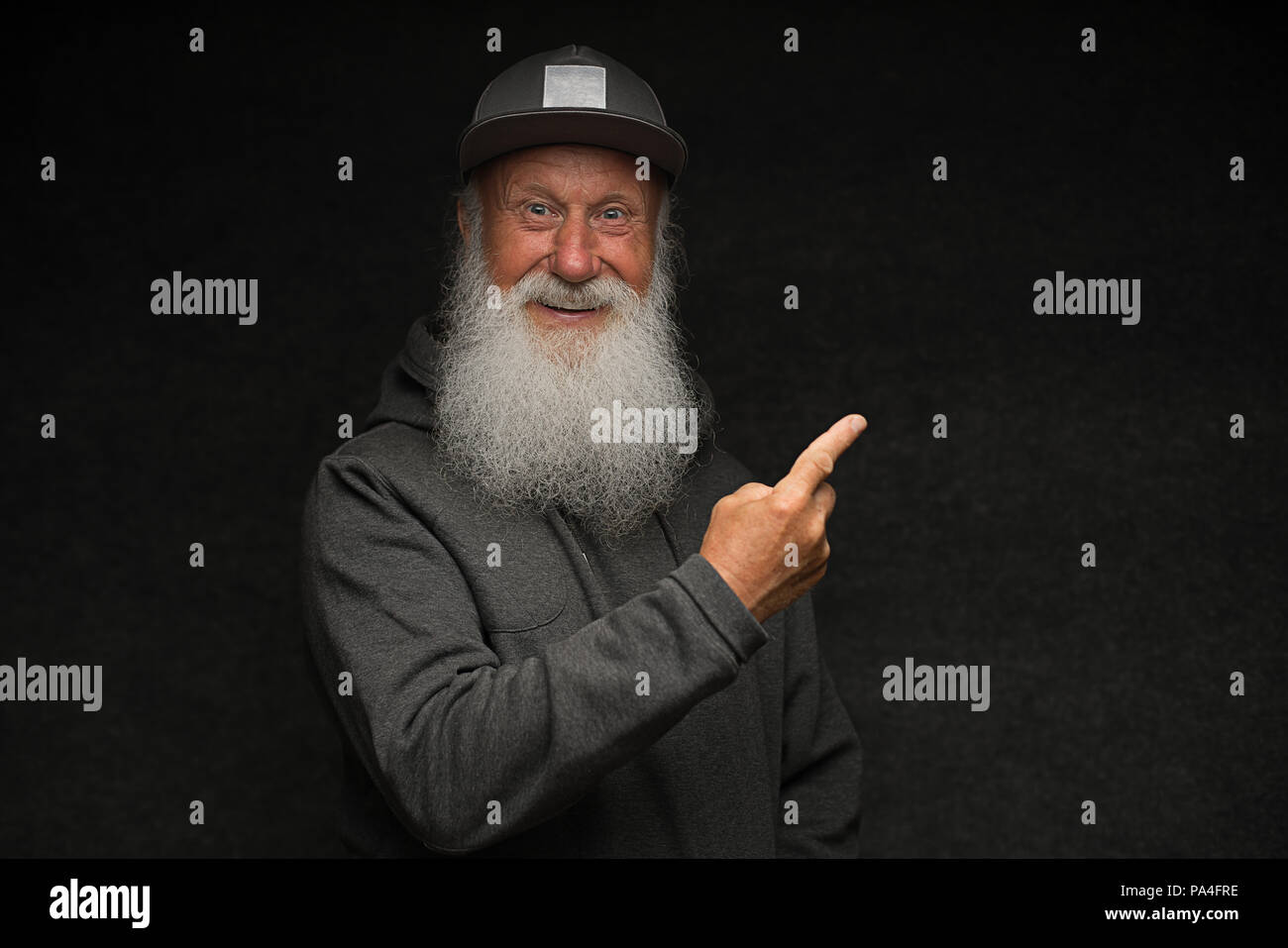 stylish old man with a gray beard on black background Stock Photo