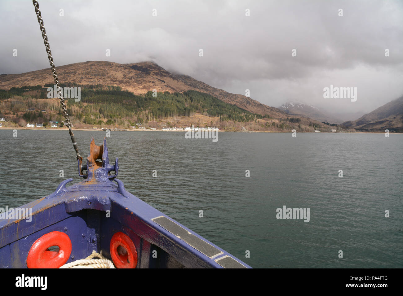 The bow of the ferry boat connecting the port town of Mallaig with Inverie (in the distance) on the Knoydart Peninsula, Scotland, United Kingdom. Stock Photo