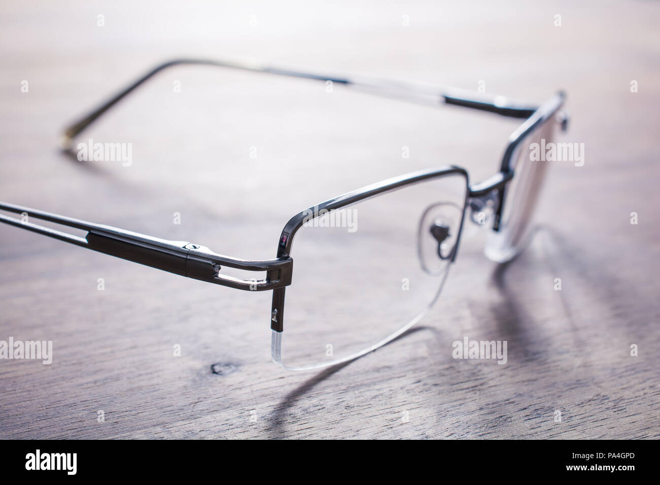 Eyeglasses On Wooden Table With Bright Background Stock Photo