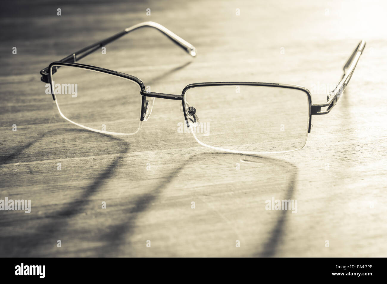 Spectacles On Wooden Table With Bright Background Stock Photo
