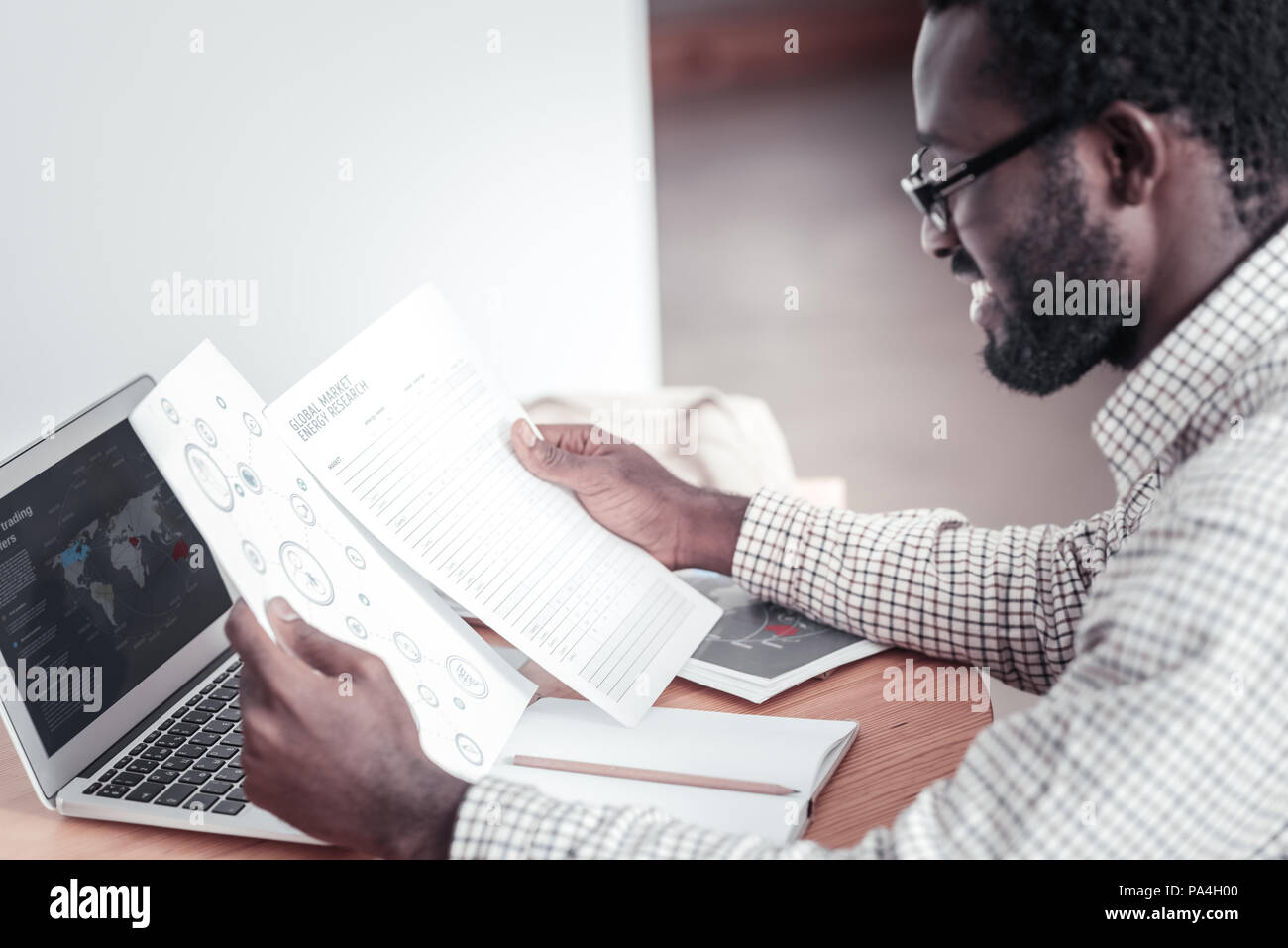 Delighted professional man working on his project Stock Photo
