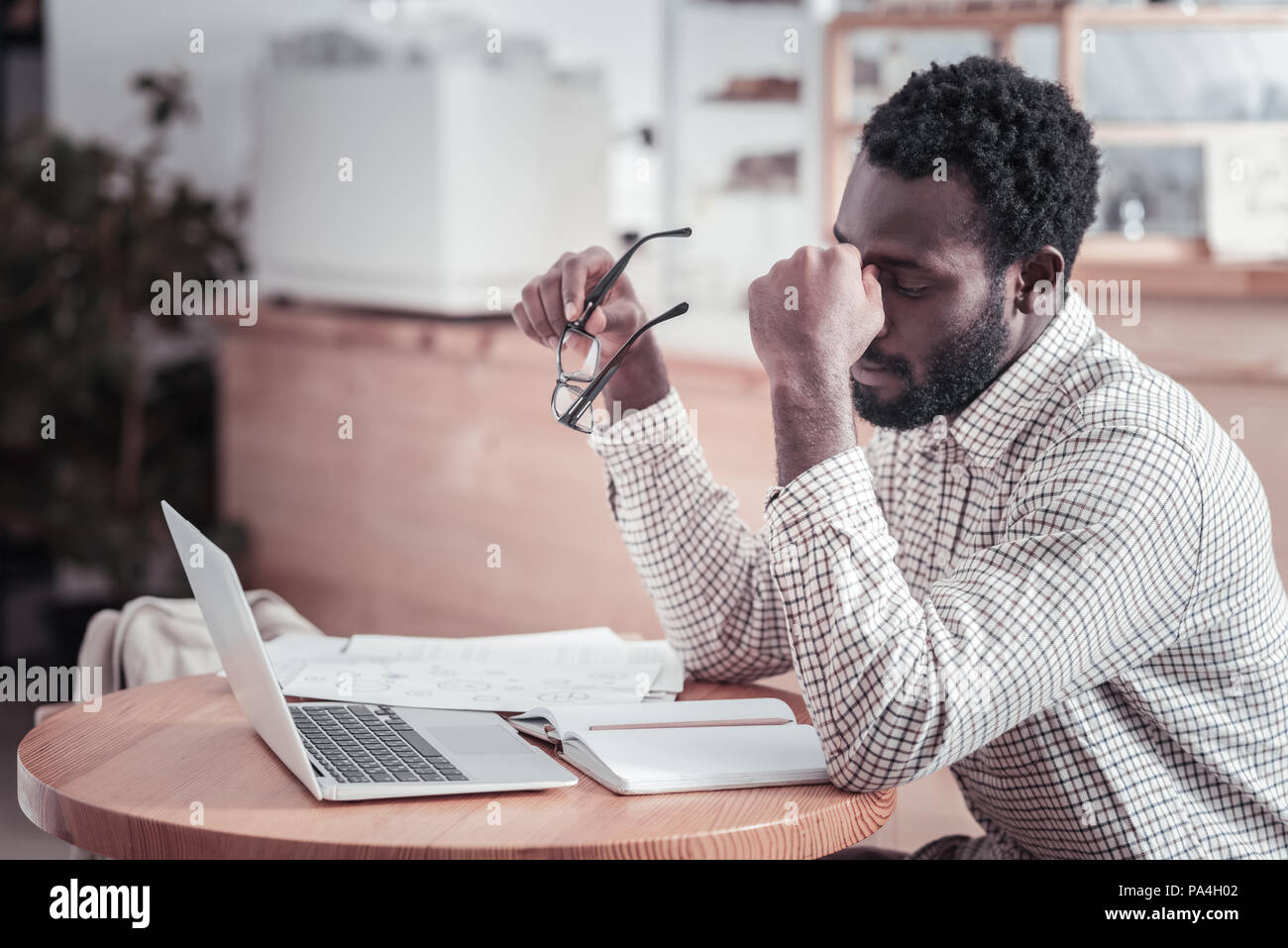 Nice tired man touching his forehead Stock Photo