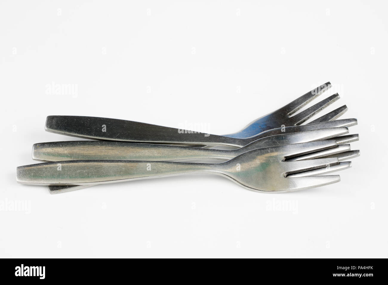 Cutlery arranged on a white kitchen table. Accessories for kitchen and