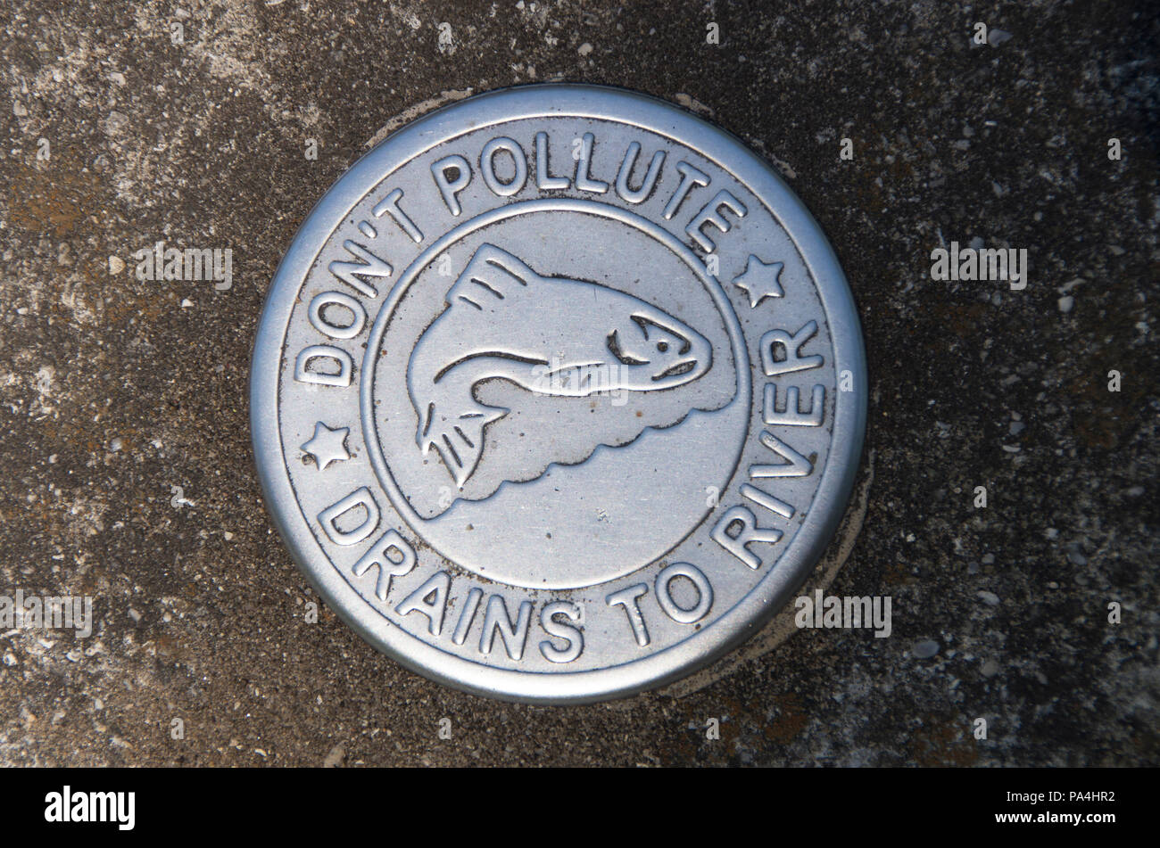 A sign warning of possible pollution to a waterway along a path near a park in Wilmington, North Carolina. Stock Photo