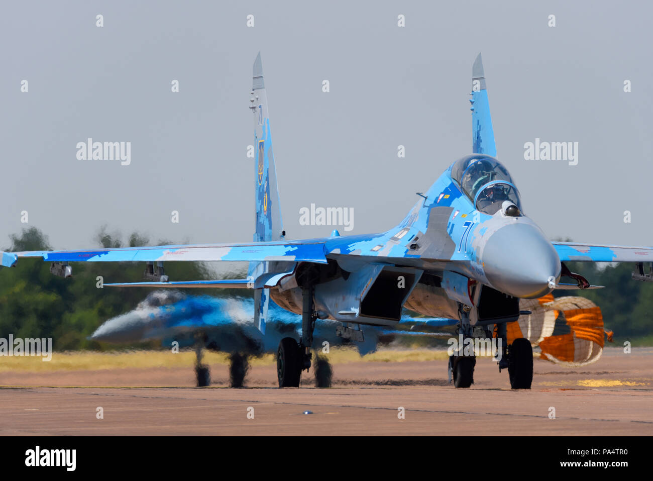 Ukrainian Air Force Sukhoi Su27 Flanker fighter jets taxiing in at the Royal International Air Tattoo RIAT 2018 RAF Fairford, UK. Dragging brake chute Stock Photo