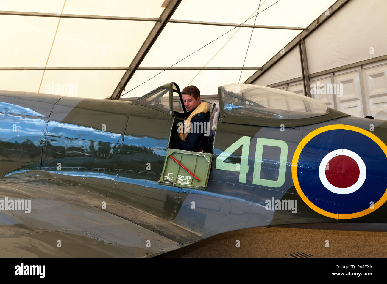 Man in period pilots uniform, poses in the cockpit of a Supermarine ...