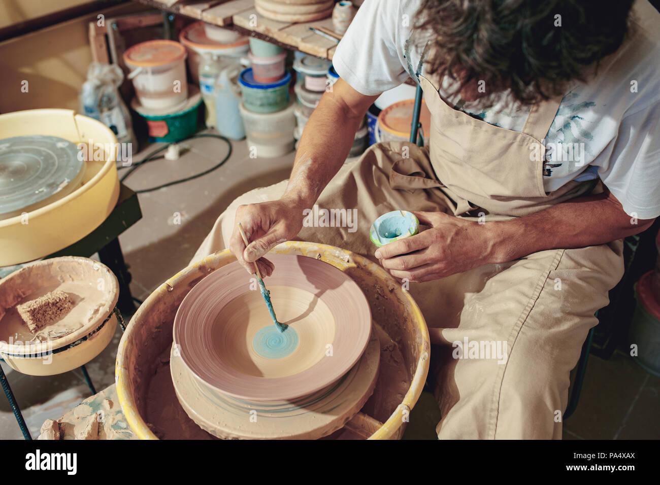 Creating a jar or vase of white clay closeup. Master crock Stock Photo