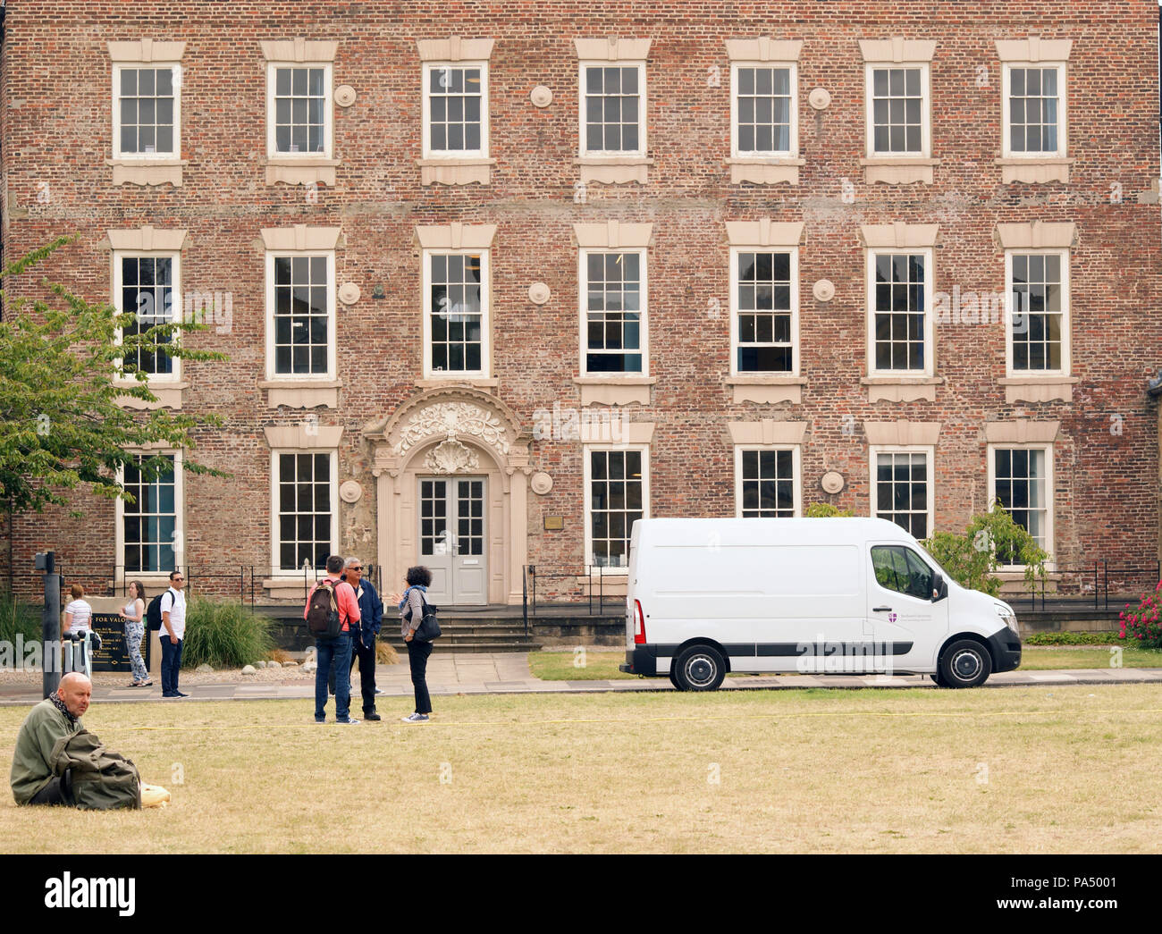 Large House on the Palace Green in Durham England. White Van Parked Outside and Tourists Walking Around Stock Photo