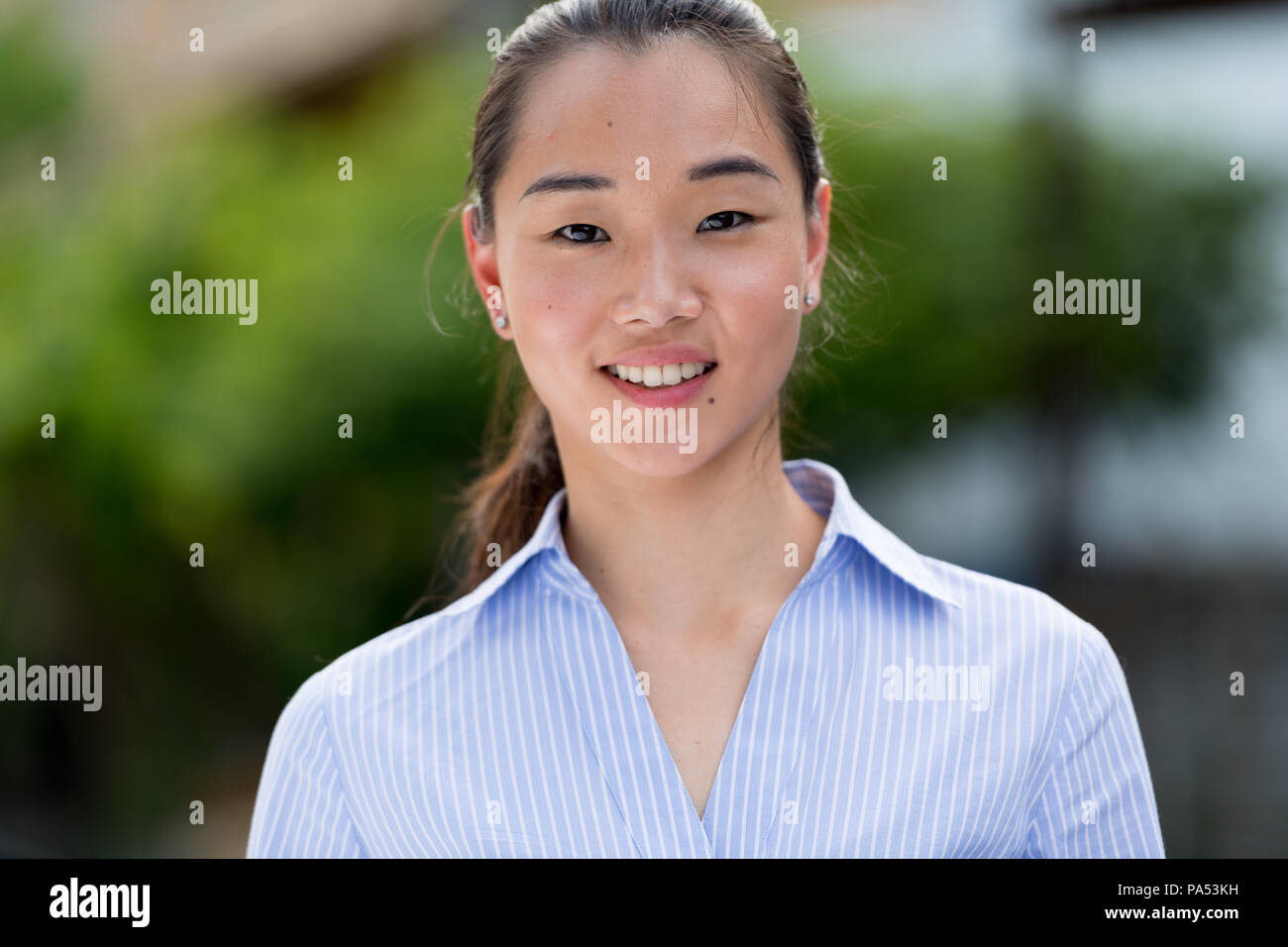 Young beautiful Asian businesswoman outdoors Stock Photo
