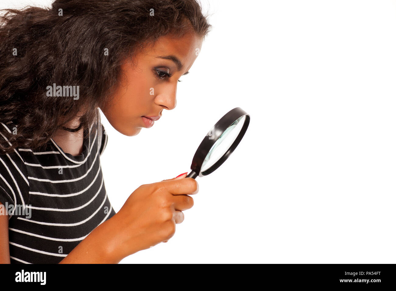 Beautiful young dark skinned woman looking trough the magnifying glass  Stock Photo - Alamy
