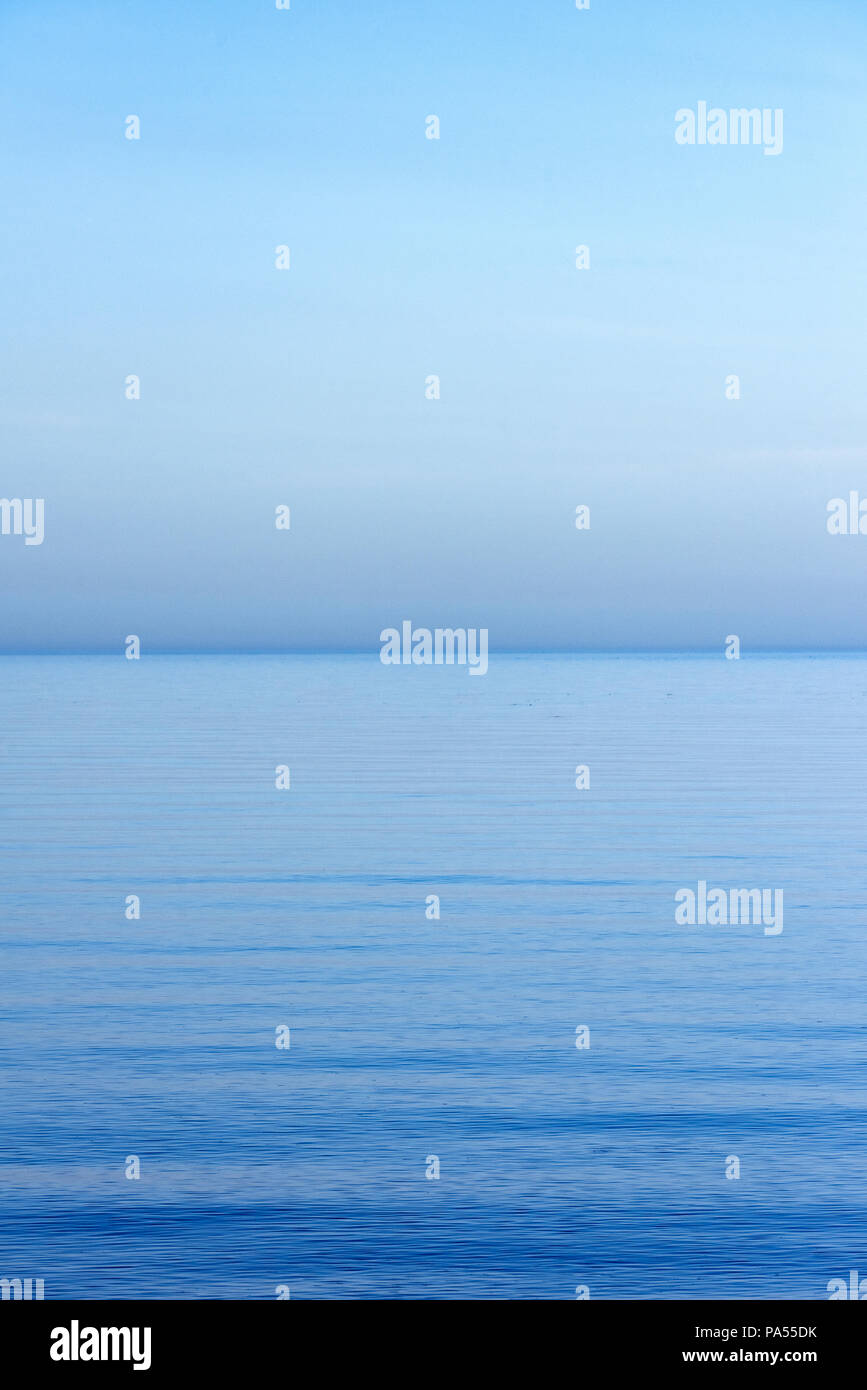 Tranquil blue sky and ocean water. Stock Photo