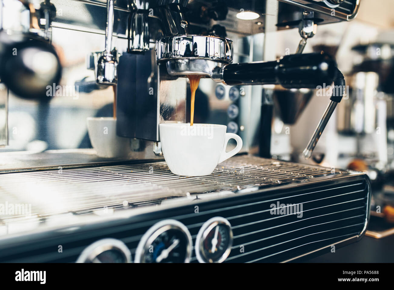 Espresso Pouring From Coffee Machine Into Coffee Cup Stock Photo Alamy
