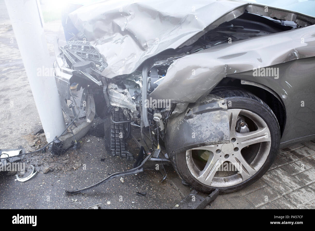 The car of a drunk driver skidded and thrown out of the road into a traffic light post. a road accident. non-insured event. Stock Photo