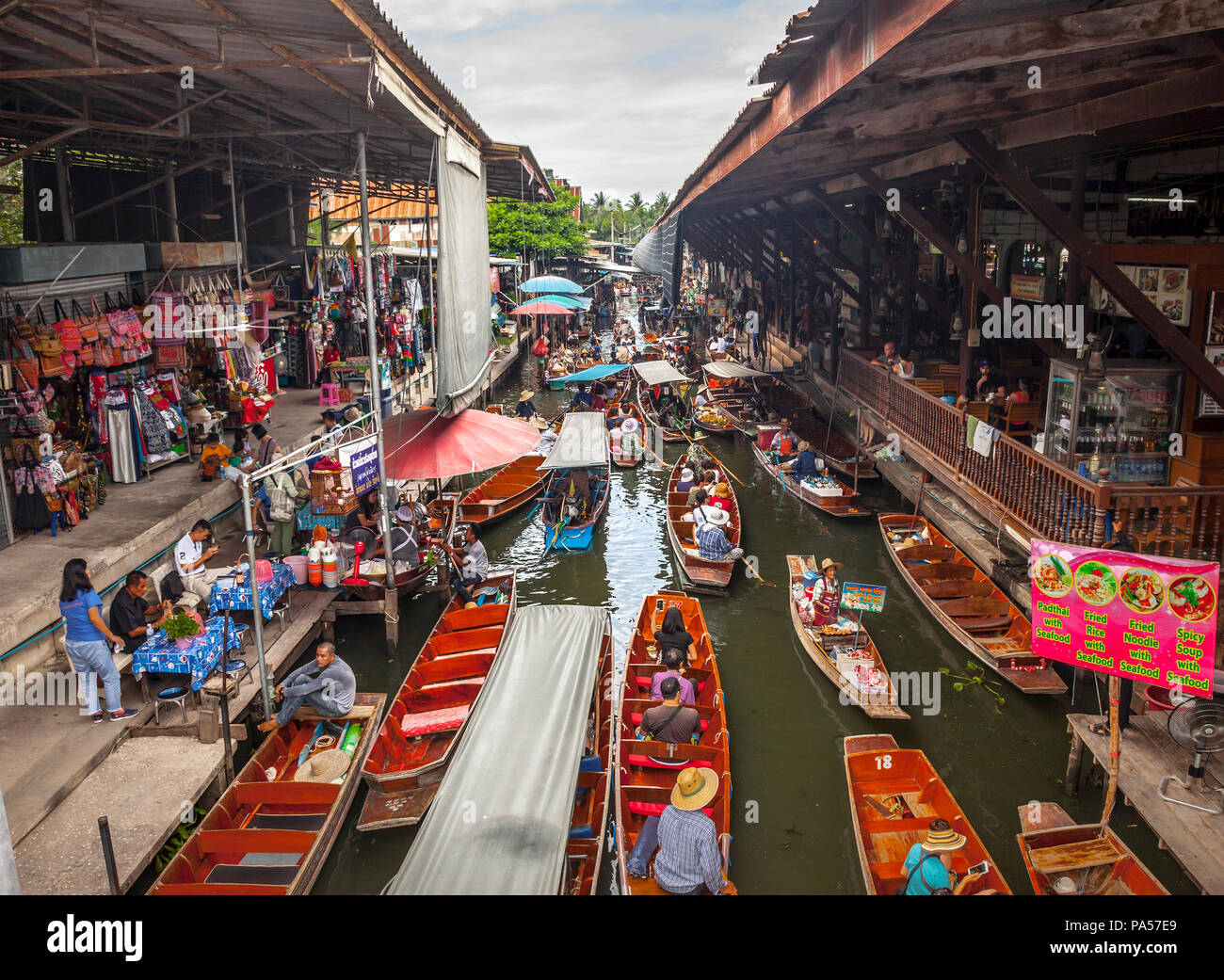Damnoen Saduak (Thailand) - 7 June 2017: Lots of tourists are visiting the famous Damnoen Saduak Floating Market, the most popular floating market in  Stock Photo
