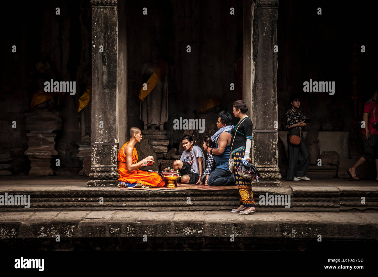 Siem Reap (Cambodia) - 13 June 2017: buddhist monk talking with a family Stock Photo