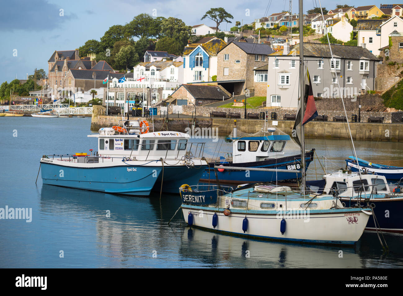 Colourful seaside homes and boats on the harbour in Brixham, Devon